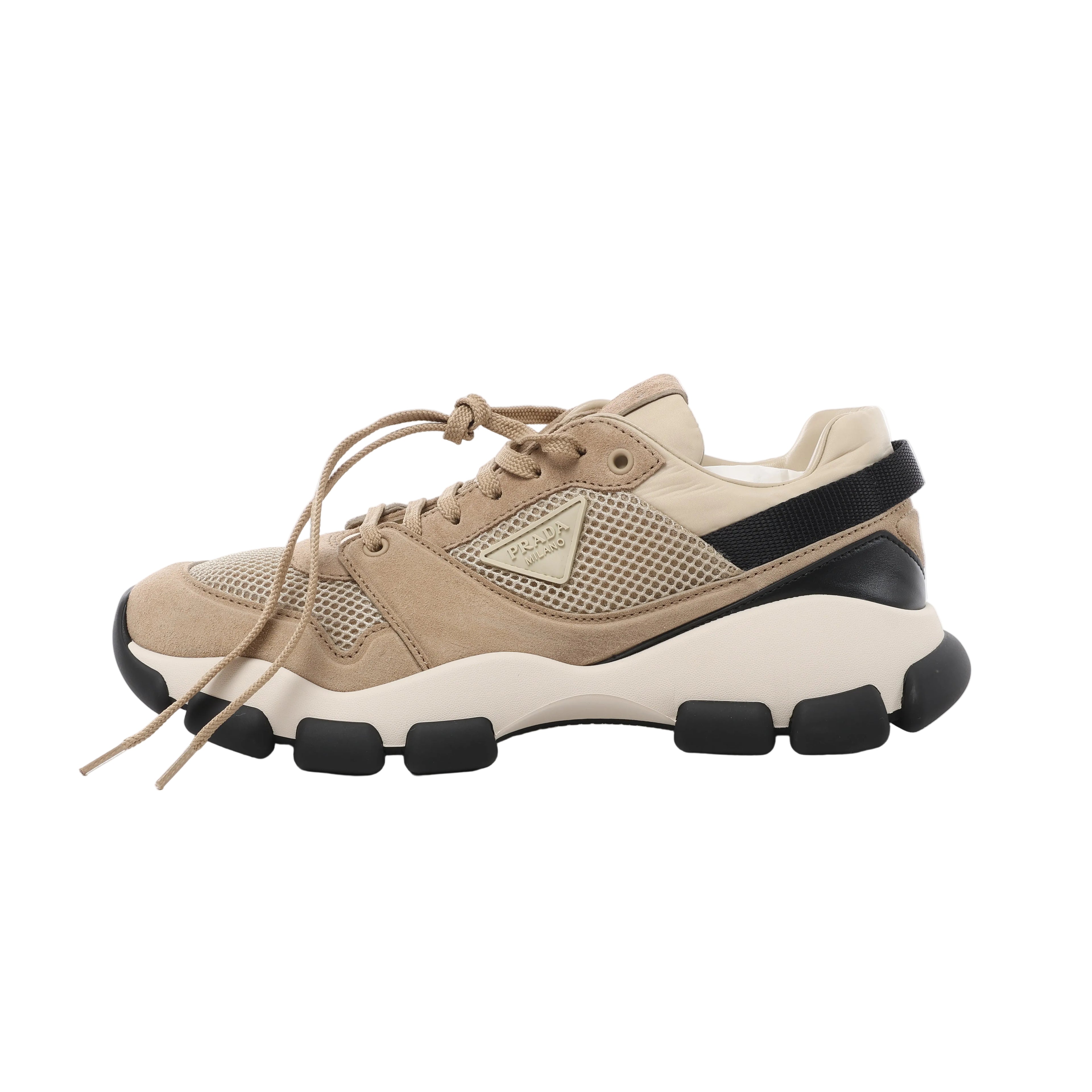 Beige Prada mesh and suede sneaker with lace-up front, black accents, chunky contrast sole and Prada triangle logo.