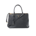 Black Prada Galleria Saffiano leather handbag with gold-tone zipper, triangle logo plaque, double top handles, and detachable shoulder strap on white background