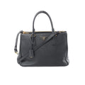 Black Prada Galleria Saffiano leather handbag with gold-tone zipper, triangle logo plaque, double top handles, and detachable shoulder strap on white background