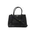 Front view of Prada Galleria black Saffiano leather handbag with twin top handles, matching shoulder strap, triangular Prada logo and gold-tone hardware.