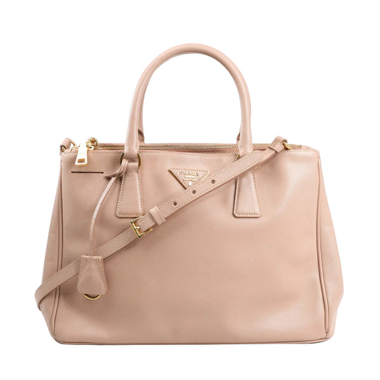 Prada Galleria 2Way Handbag in pink Saffiano Lux leather with top handles, detachable shoulder strap, gold-tone hardware, and triangle logo plaque on a white background.