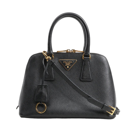 Prada Promenade handbag in black Saffiano Lux leather with signature crosshatch texture, gold-tone hardware, dual top handles, and adjustable shoulder strap.