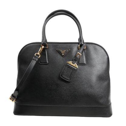 Prada Promenade 2Way Handbag in black Saffiano Lux leather featuring a dome silhouette, dual top handles, detachable shoulder strap, gold-tone hardware, and signature logo plaque.