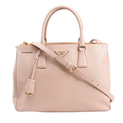 Prada Galleria 2Way handbag in pink Saffiano Lux leather featuring dual rolled handles, detachable shoulder strap, gold-tone hardware, and iconic triangle logo plaque.