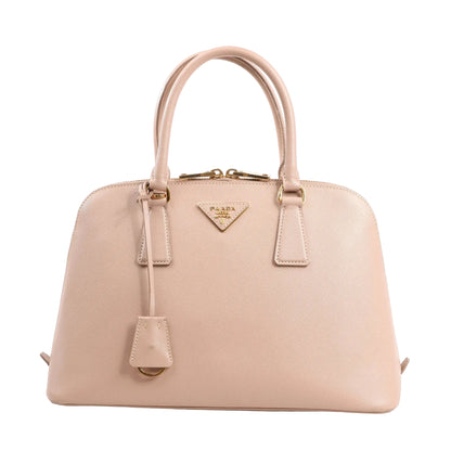 Prada Promenade 2Way handbag model 1BA837 in beige Saffiano Lux leather, featuring dual top handles, structured dome shape, gold-tone logo plaque, and a detachable leather clochette.
