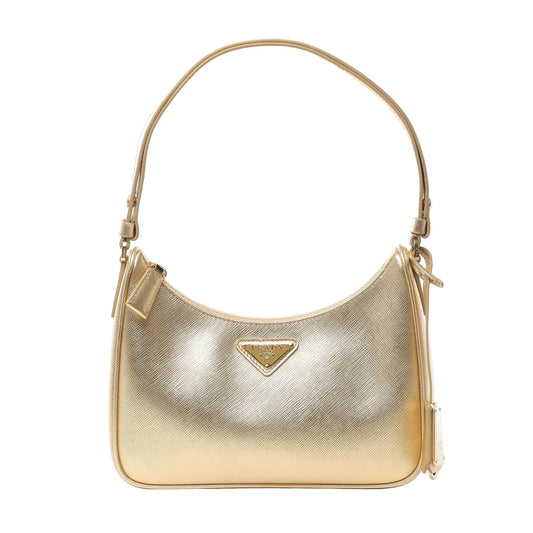 Front view of Prada Saffiano Lux Mini Re-Edition Shoulder Bag 1BC204 in metallic gold Platino leather, featuring signature crosshatch texture, gold-tone Prada logo plaque, and single shoulder strap against a white background.