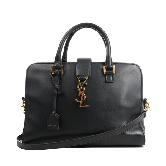 Saint Laurent Monogram Cabas black leather handbag with gold YSL logo, top handles, and detachable shoulder strap.