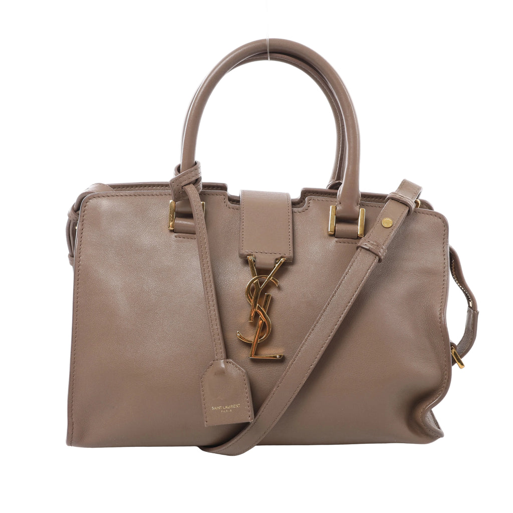 Beige Saint Laurent Baby Cabas leather handbag with twin rolled handles, a matching shoulder strap, gold-tone YSL monogram and hanging leather tag.