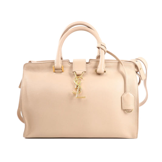 Saint Laurent Paris Baby Cabas 394461 handbag in beige leather with gold YSL logo, dual top handles, detachable shoulder strap, and structured silhouette.