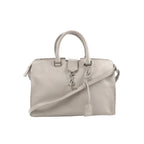 Gray Saint Laurent Baby Cabas leather handbag with double top handles, detachable shoulder strap, silver-tone YSL logo charm, and hanging leather clochette.