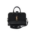 Saint Laurent Baby Cabas black leather handbag with top handles, detachable shoulder strap, and gold-tone YSL logo on the front, on a white background.