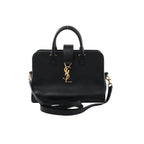 Saint Laurent Baby Cabas black leather handbag with top handles, detachable shoulder strap, and gold-tone YSL logo on the front, on a white background.
