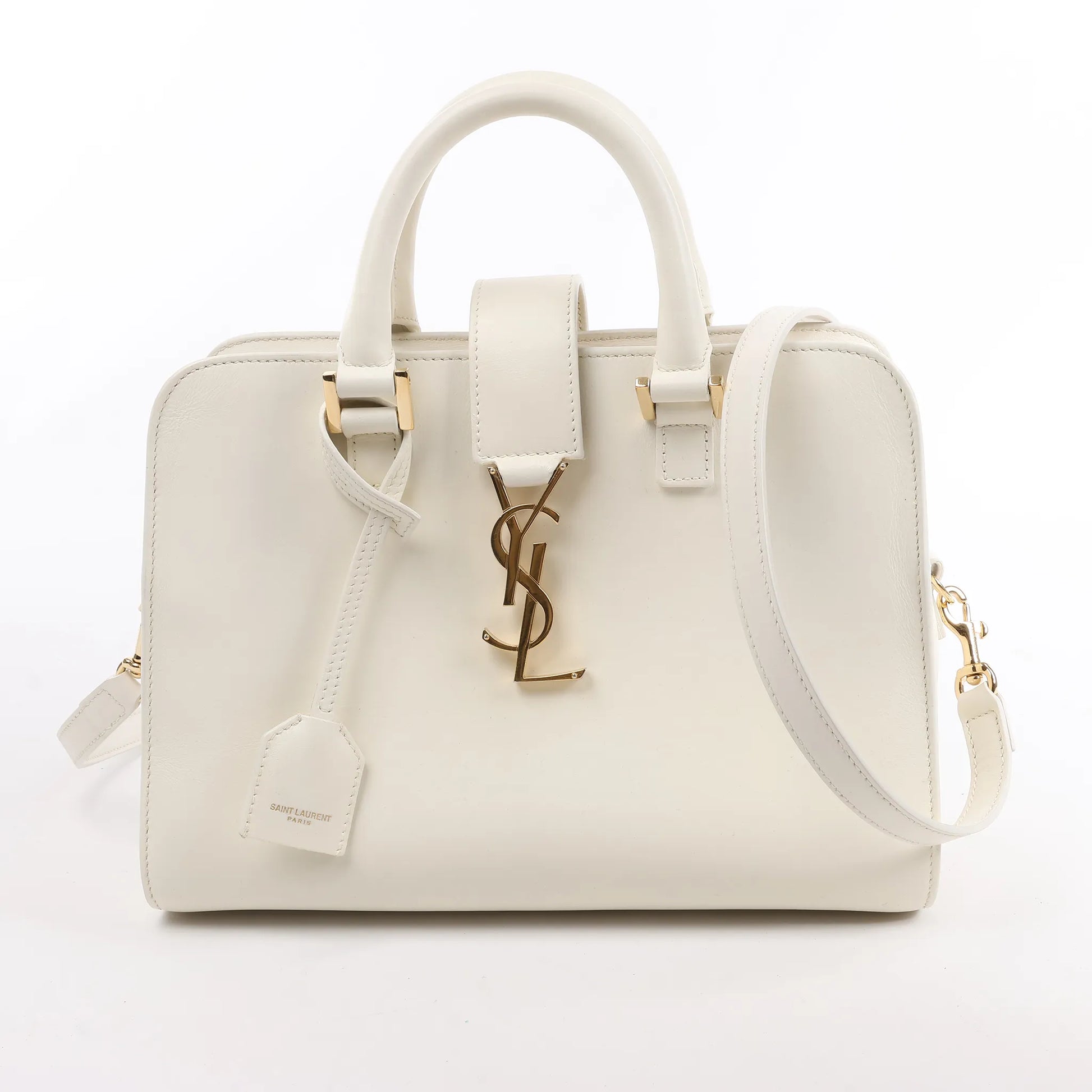 Front view of the Saint Laurent Paris Monogram Cabas Leather 2Way Handbag 472466 in white, showcasing smooth leather exterior, gold YSL logo hardware, top handles, detachable shoulder strap, and matching leather clochette, displayed against a white background.