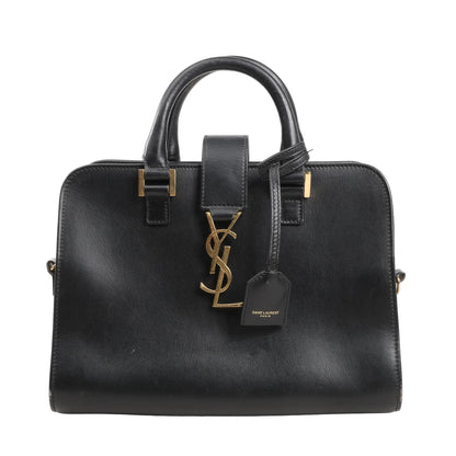 Saint Laurent Paris Baby Cabas handbag in smooth black leather with structured top handles, gold YSL logo hardware, and leather luggage tag.
