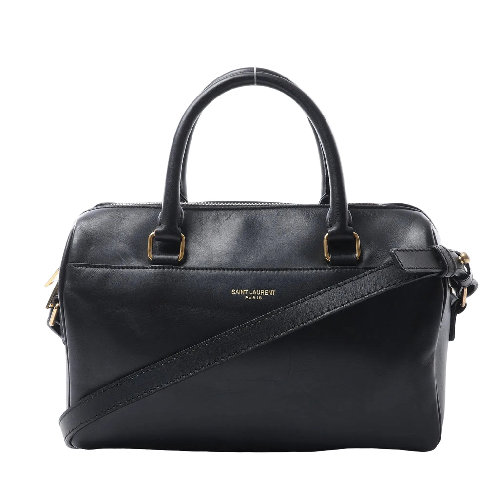Saint Laurent Baby Duffle black leather handbag with rolled top handles, detachable shoulder strap, gold-tone hardware and top zip closure.