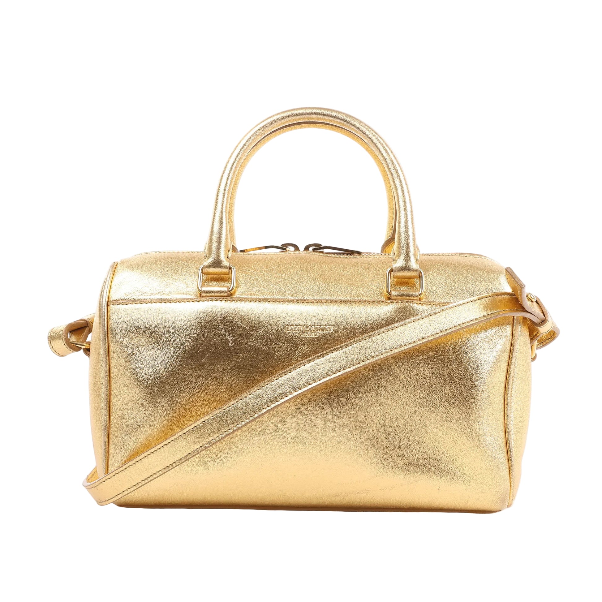 Saint Laurent Paris Baby Duffle handbag 330958 in metallic gold leather with dual rolled handles, detachable shoulder strap, and structured barrel-shaped design against a white background.