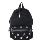 Black Saint Laurent City canvas backpack with black leather trim, silver zipper hardware, top handle, and front zip pocket with silver star patches on white background.
