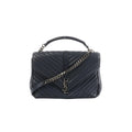 Saint Laurent College navy chevron-quilted leather handbag with top handle, silver-tone chain strap, and YSL monogram on front flap, front view on white background.