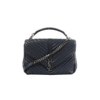 Saint Laurent College navy chevron-quilted leather handbag with top handle, silver-tone chain strap, and YSL monogram on front flap, front view on white background.