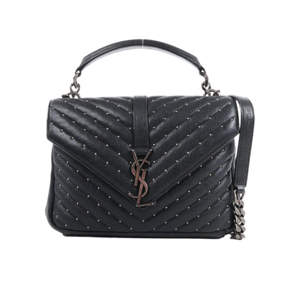 Black quilted handbag with chain detail on a white background