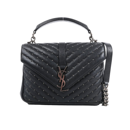 Black quilted handbag with chain detail on a white background
