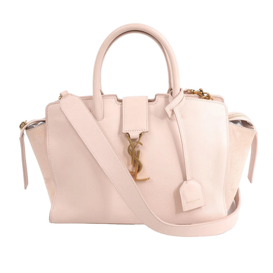Front view of the Saint Laurent Paris Downtown Cabas 2Way Handbag in pink, showcasing smooth leather and suede side panels, structured silhouette, top handles, detachable shoulder strap, gold YSL logo, and leather clochette, displayed against a white background.