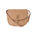Beige Saint Laurent Kaia leather shoulder bag with curved flap, slim strap and gold-tone YSL monogram clasp.