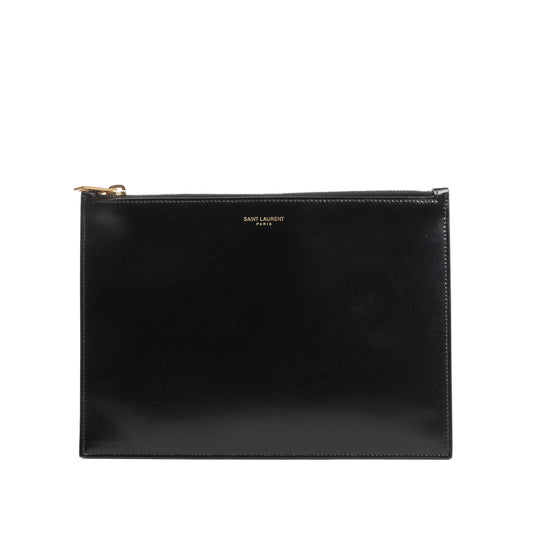 Saint Laurent Paris leather clutch in black featuring a sleek rectangular design, smooth finish, gold-tone top zip closure, and subtle “SAINT LAURENT PARIS” logo at the top center.