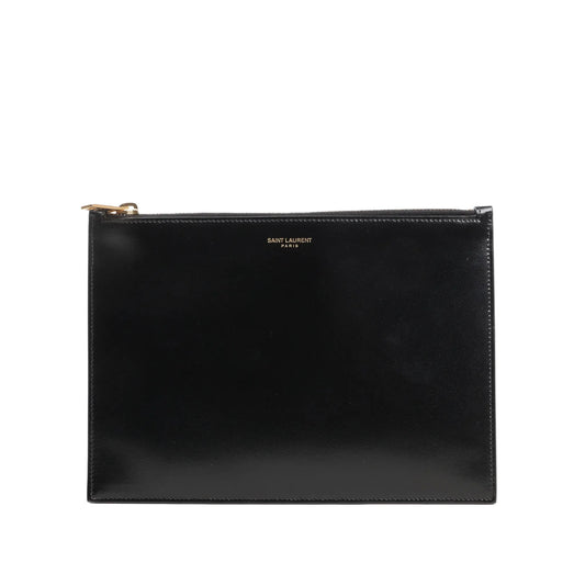 Saint Laurent Paris leather clutch in black featuring a sleek rectangular design, smooth finish, gold-tone top zip closure, and subtle “SAINT LAURENT PARIS” logo at the top center.