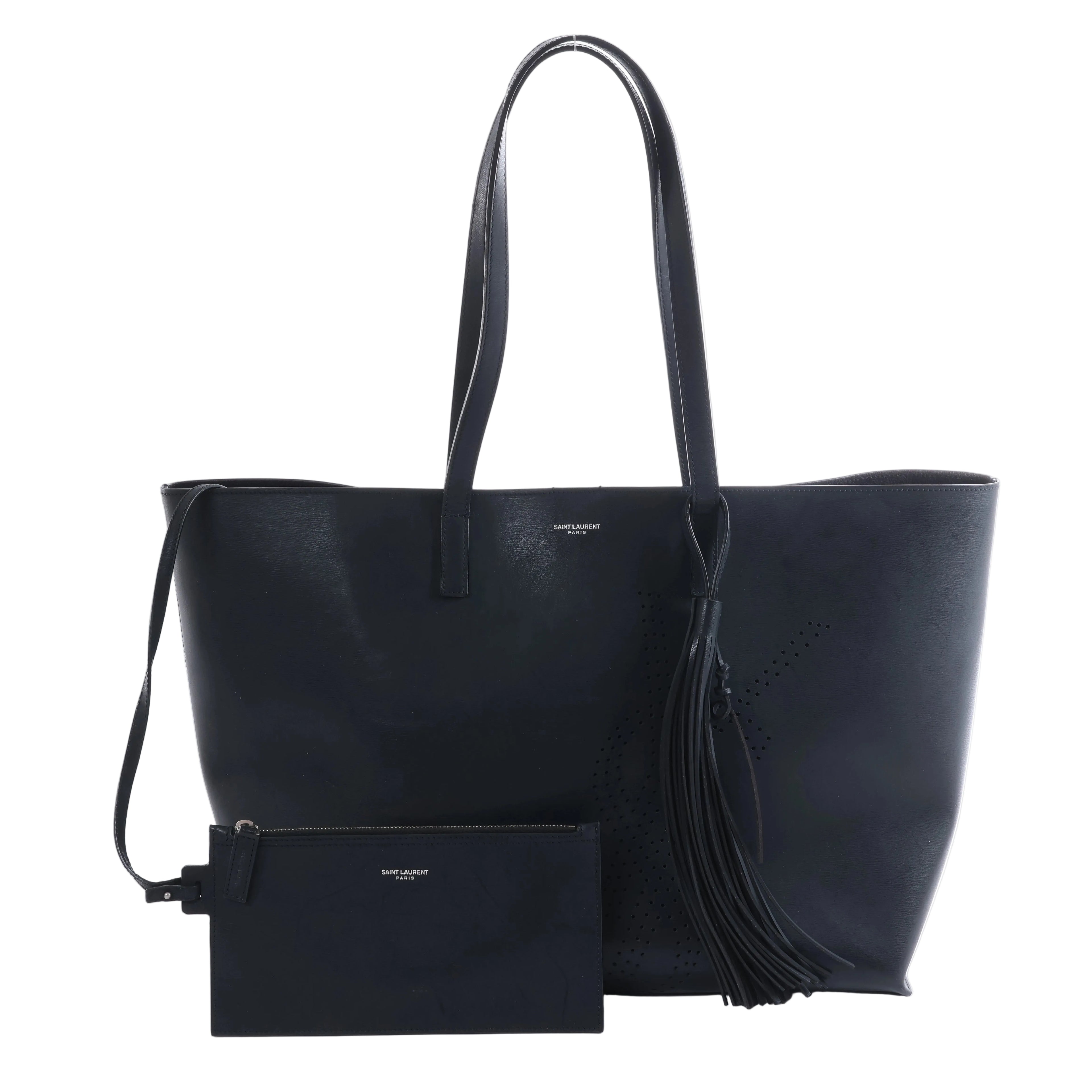 Black Saint Laurent leather tote bag with two slim shoulder straps and a matching black zip pouch displayed beside it.
