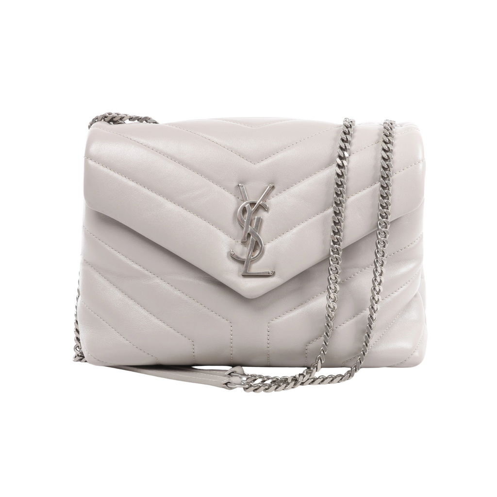 Front view of a light grey Saint Laurent Loulou bag with padded chevron quilting, an envelope flap, silver-tone YSL logo and chain shoulder strap.
