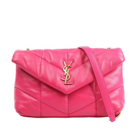 Saint Laurent Paris Loulou Puffer shoulder bag in bright pink quilted lambskin leather, featuring gold-tone YSL logo on the front flap, soft chevron stitching, and a matching leather-and-chain shoulder strap, displayed against a white background.