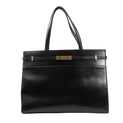 Front view of Saint Laurent Paris Manhattan Tote Bag in black smooth leather, featuring structured silhouette, slim leather strap detail, gold-tone square clasp, and dual leather shoulder handles.
