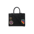Black Saint Laurent Sac de Jour Small leather handbag with top handles, long shoulder strap and colorful decorative patches on the front.