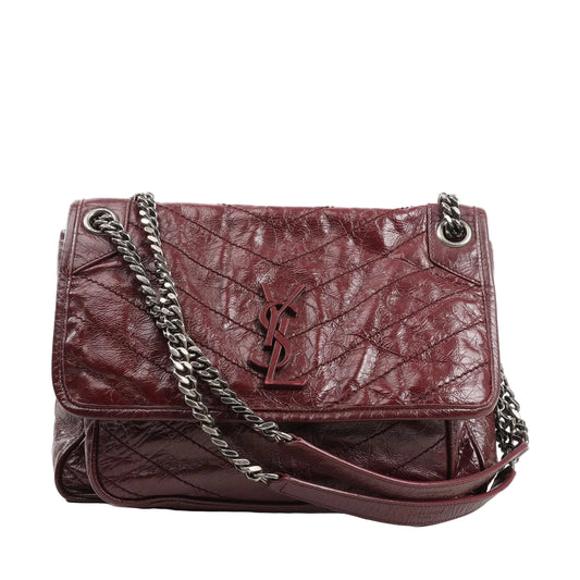 Saint Laurent Paris Niki chain shoulder bag 498894 in burgundy crinkled leather, featuring chevron quilting, tonal YSL logo on the flap, and a sliding silver-tone chain strap with leather shoulder pad.