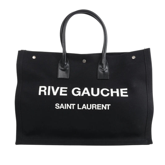 Saint Laurent Rive Gauche Large Tote Bag 509415 in black canvas with white printed logo, dual black leather handles, and structured rectangular design against a white background.