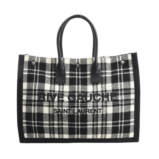 Saint Laurent Paris Rive Gauche Tote Bag 499290 in black and white plaid wool with black leather handles, front logo lettering, and structured rectangular shape against a white background.