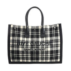 Saint Laurent Paris Rive Gauche Tote Bag 499290 in black and white plaid wool with black leather handles, front logo lettering, and structured rectangular shape against a white background.