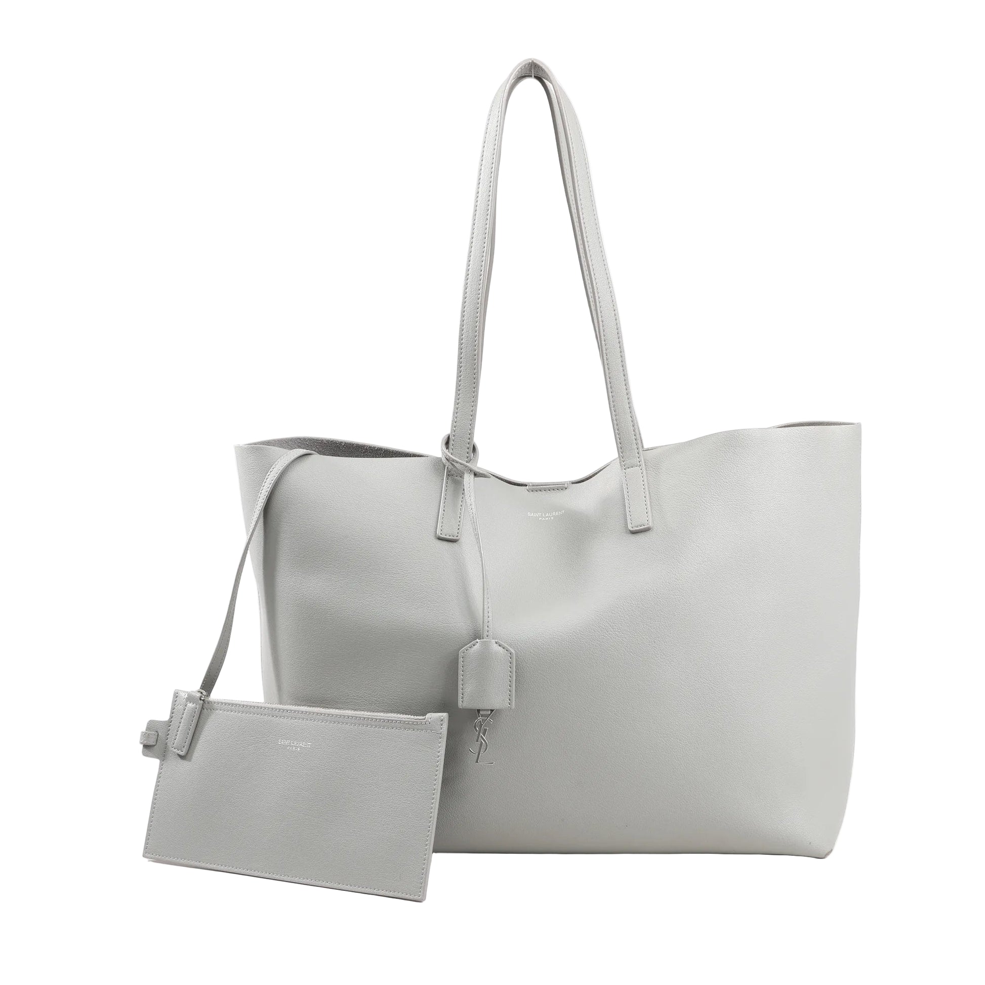 Saint Laurent Paris Shopping Tote 600281 in gray leather featuring dual thin shoulder straps, minimalist design, hanging YSL charm, and detachable zip pouch.