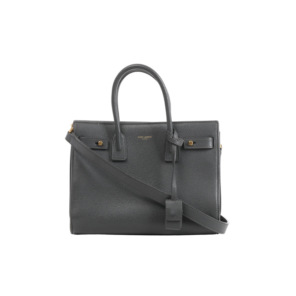 Gray Saint Laurent Sac de Jour Small grainy leather handbag with double top handles, shoulder strap, gold-tone hardware and front logo.