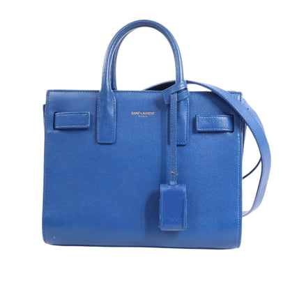 Blue handbag with a strap on a white background