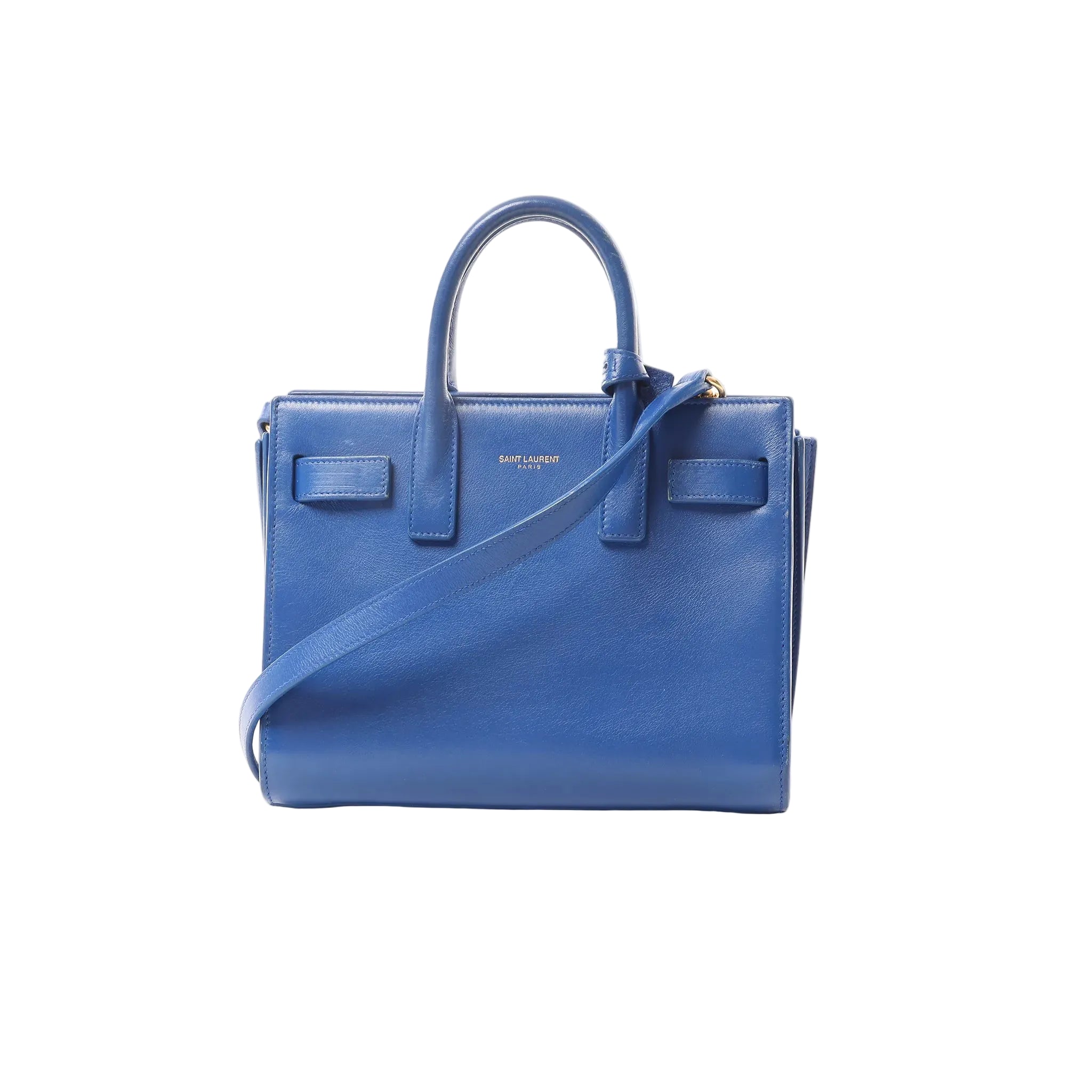 Blue Saint Laurent Paris Sac de Jour Nano leather 2-way handbag with top handles, detachable shoulder strap, and small Saint Laurent Paris logo on front, on white background.
