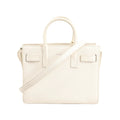 Saint Laurent Sac de Jour Nano handbag in white grained leather featuring dual top handles, detachable shoulder strap, and structured silhouette with minimal branding.