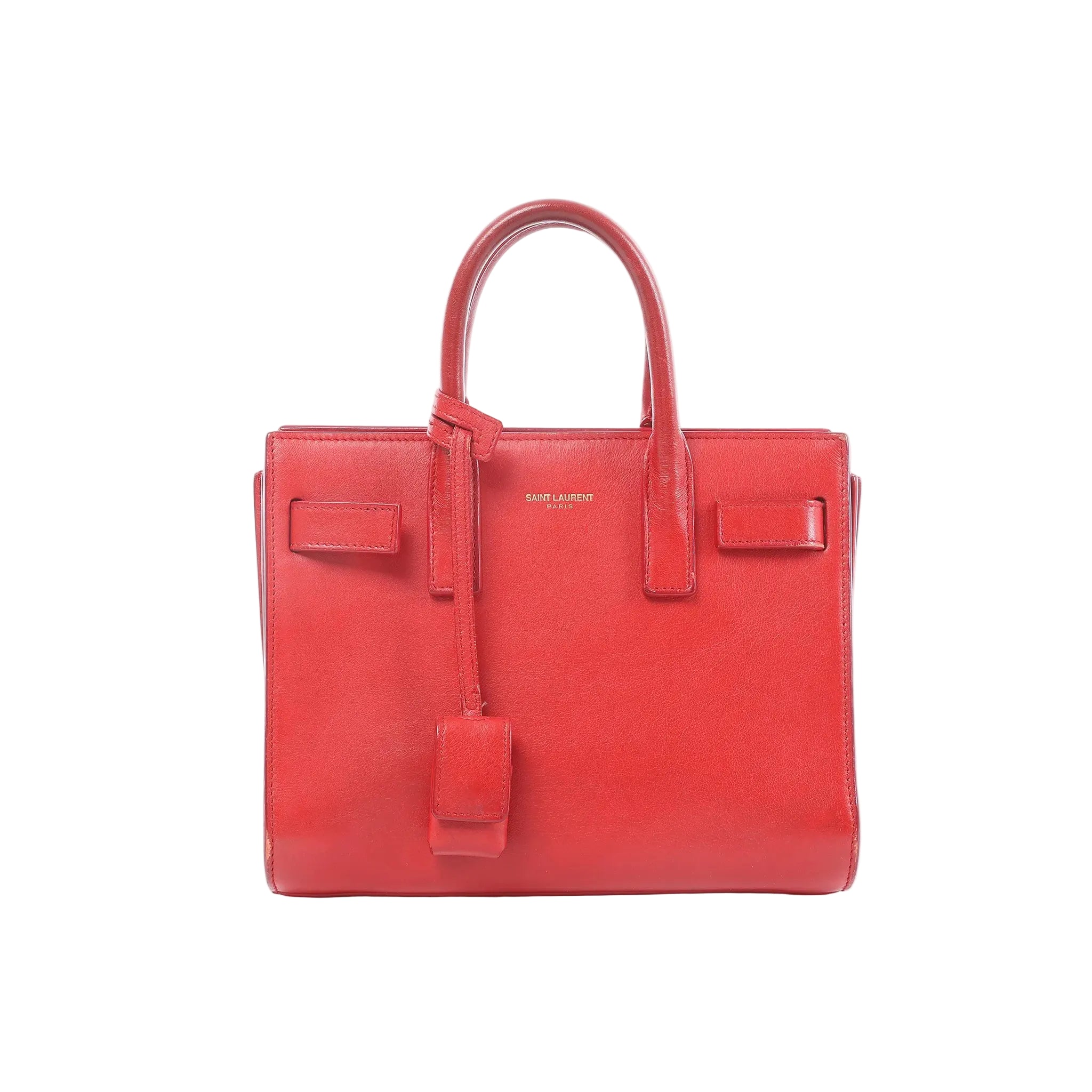 Saint Laurent Sac de Jour Nano red leather structured handbag with top handles, hanging clochette, and gold logo text on front, on white background