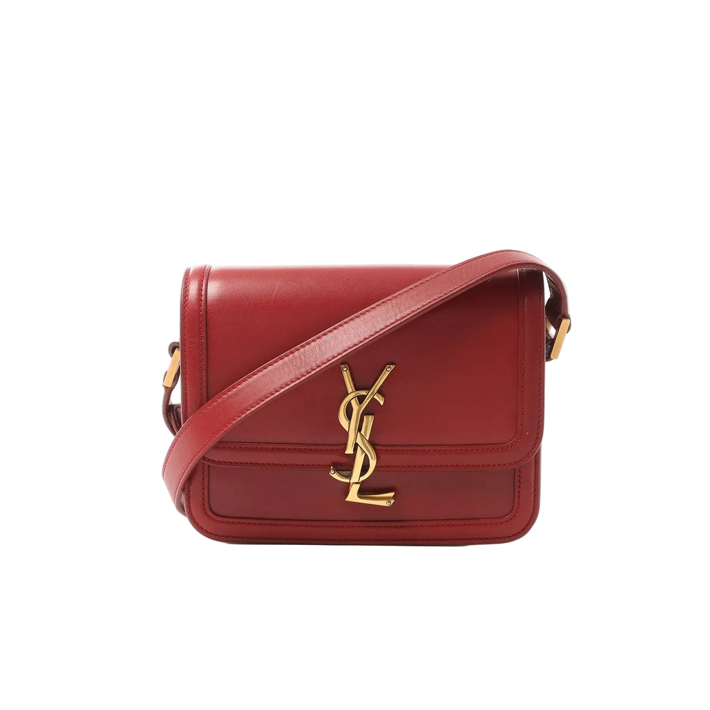 Red Saint Laurent Solferino leather crossbody bag with gold-tone YSL logo on the front and matching leather shoulder strap
