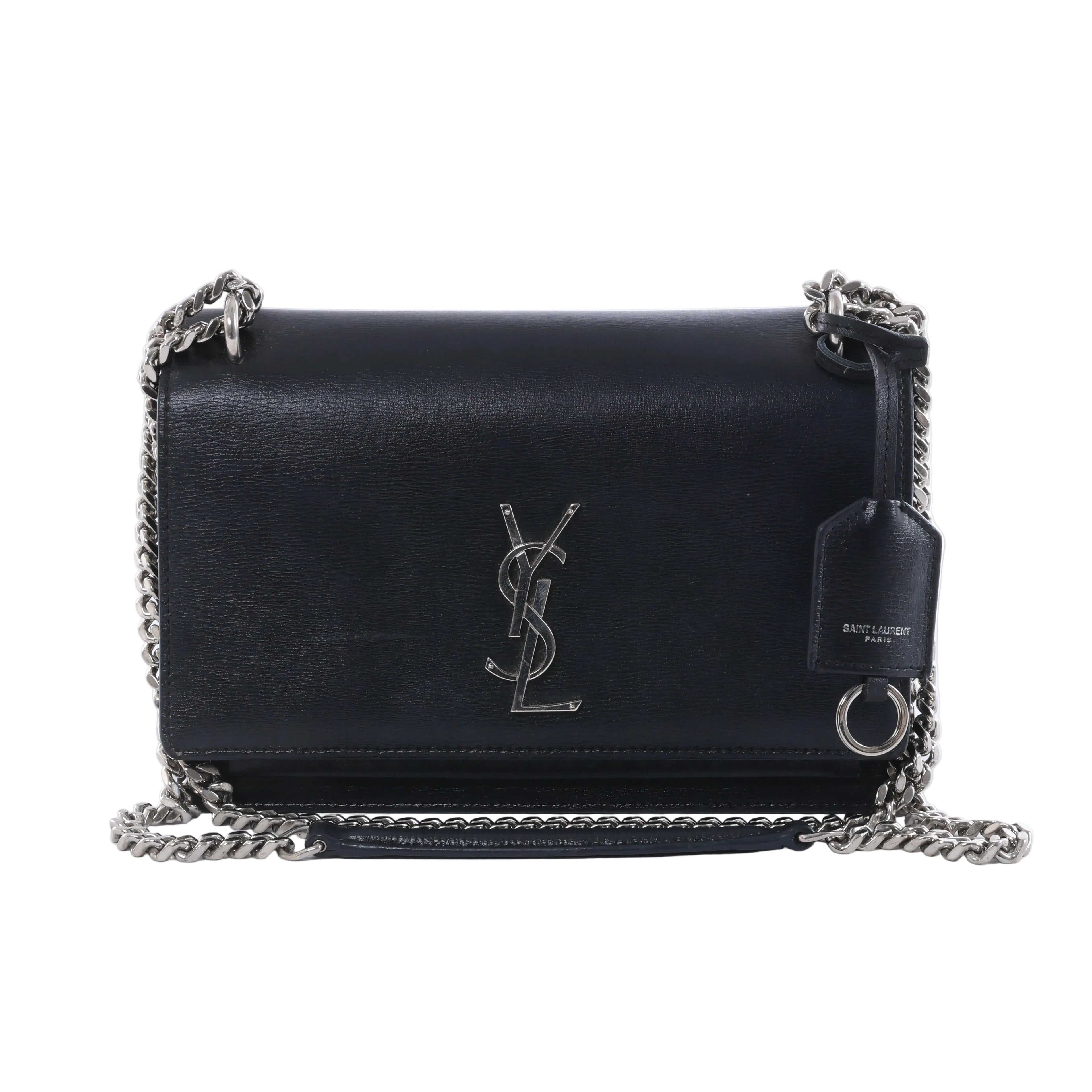 Saint Laurent Sunset black leather crossbody bag with silver-tone YSL logo, chain strap, flap front and leather tag.