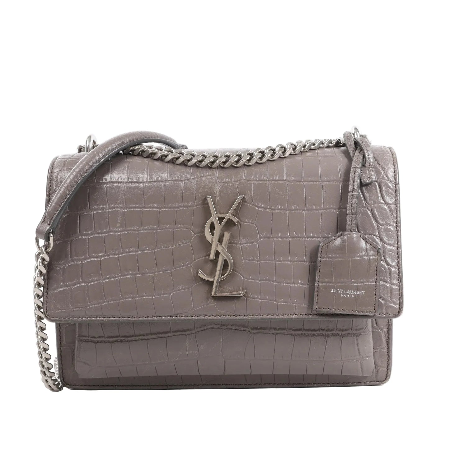 Front view of the Saint Laurent Paris Sunset Medium Mock Croc Shoulder Bag in gray, showcasing embossed crocodile-textured leather, silver-tone YSL logo hardware, chain shoulder strap, and leather tag detail, set against a white background.