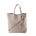 Saint Laurent Toy Shopping 2-way handbag in beige leather with slim top handles, detachable shoulder strap, gold-tone hardware and YSL charm.