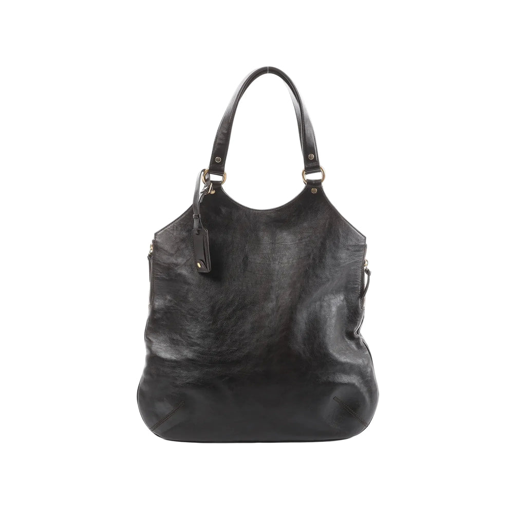Saint Laurent Tribute Large brown leather shoulder bag with long shoulder straps, gold-tone ring hardware, and hanging leather tag on a white background.