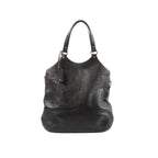 Saint Laurent Tribute Large brown leather shoulder bag with long shoulder straps, gold-tone ring hardware, and hanging leather tag on a white background.